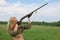 Attractive hunter aiming with hunting double-barreled rifle