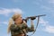 Attractive hunter with hunting double-barreled rifle looking out the trophy