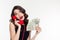 Attractive joyful curly female holding money and talking on telephone