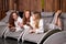 Attractive ladies drinking herbal tea resting in spa salon, relaxing