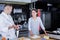 Attractive lady learning cooking secrets from a chef