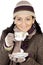 Attractive lady sheltered for the winter drinking a tea cup
