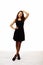 Attractive Latina Woman Standing Black Dress Arm On Head
