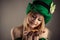 Attractive leprechaun girl with coins in hands