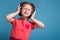 Attractive little cute girl in pink dress and headphones