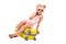 Attractive little girl in white shirt, pink shorts and sunglasses sit on the yellow suitcase and talk on the phone