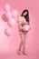 Attractive love teen brunette with balloons holding bouquet of r