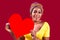 attractive lovely south woman with turban holding in hands heart isolated over red background valentine& x27;s day february