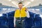 Attractive male flight attendant in a lifejacket looking ahead
