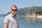 Attractive man and big vintage yacht in port of Tivat