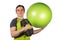 Attractive man with green fitball and black dumbbell in his hands isolated on white background