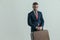 Attractive man with grizzled hair holding luggage and leaving town