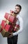 Attractive man with many present boxes in his arms