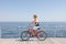 Attractive man riding bike near sea