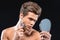 Attractive man shaving his stubble