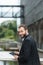 Attractive man standing on an urban bridge