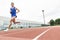 Attractive man Track Athlete Running On Track.