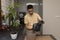 An attractive man transplanted an avocado seedling into a new, larger pot