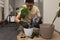 An attractive man transplanted an avocado seedling into a new, larger pot