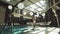 Attractive man walking by indoor pool. Man resting near swimming pool.