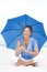 Attractive Mature woman blue umbrella beach