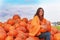 Attractive mature woman with orange pumpkins in autumn