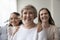 Attractive mature woman pose for picture with granddaughter and daughter