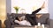 Attractive Mexican woman moving legs while lying on couch