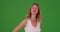 Attractive middle aged Caucasian woman looking at camera on green screen