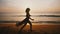 Attractive middle aged happy woman running along incredible golden sunset sea beach, concept of travel and freedom.