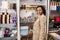 Attractive middle-aged multi-ethnic brunette woman in casual beige coat looking at camera while shopping in the International