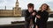 Attractive millennial couple in London, England using smartphone