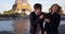 Attractive millennial couple in Paris using smartphone