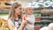 Attractive mommy with toddler kid pick up vegetable from shelf closeup