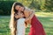 Attractive mother in a cocktail dress hugging her dear beautiful daughter long hair in the park summer trip. healthy