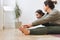 Attractive mother middle age woman and daughter teenager ptactice yoga together in bright room