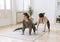 Attractive mother middle age woman and daughter teenager ptactice yoga together in the bright room