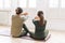 Attractive mother middle age woman and daughter teenager ptactice yoga together in the bright room