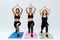 Attractive and multicultural women exercising on fitness mats