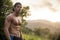Attractive muscular shirtless young man in nature