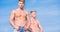 Attractive muscular twins. Muscular healthy athletic body. Men twins brothers muscular guys sky background. Sexy torso