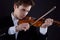 Attractive musician violinist. a man playing the violin in a string orchestra at a classical music concert