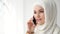 Attractive muslim woman in hijab is talking mobile phone.