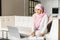 Attractive muslin woman working at home with laptop