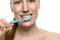 Attractive naked woman brushing her teeth