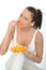 Attractive Natural Healthy Young Woman Eating a Plate of Ripe Juicy Orange Segments