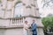 Attractive newlywed couple in loveposing near the walls of old austrian palace