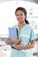 Attractive nurse holding case sheets