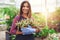 Attractive nursery owner in her greenhouse