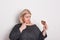 An attractive overweight woman eating a donut, feeling guilty.